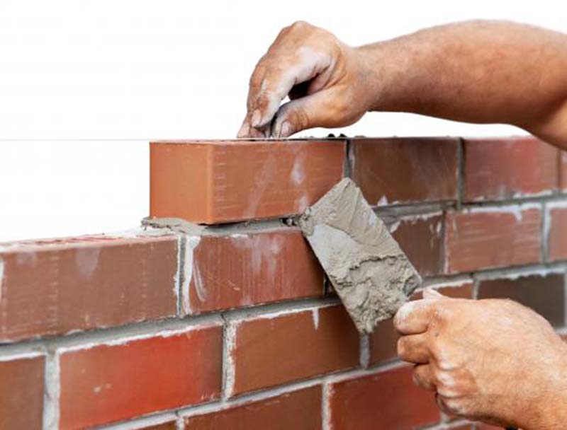 laying brick wall